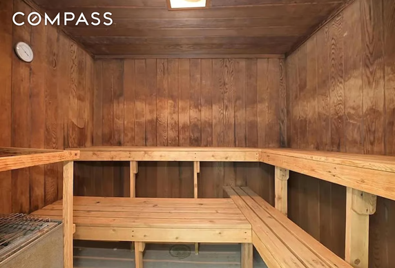 Interior view of a wooden sauna with bench seating.