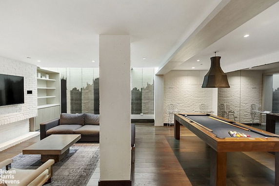 Indoor area with a pool table and seating arrangement.