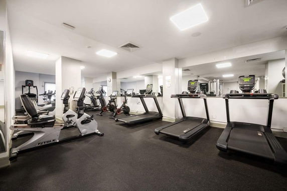 Indoor gym area with treadmills and exercise bikes.