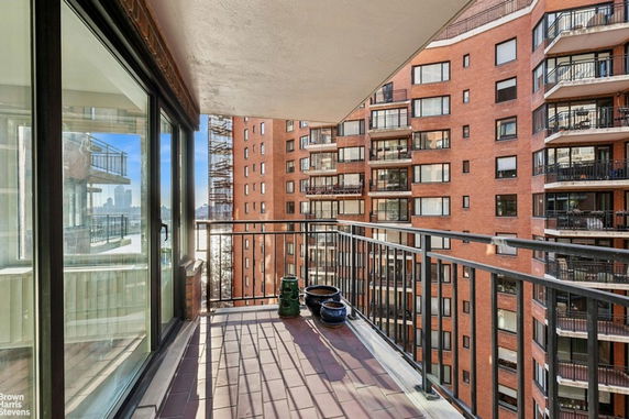 View from a balcony looking towards adjacent apartment buildings with multiple balconies.