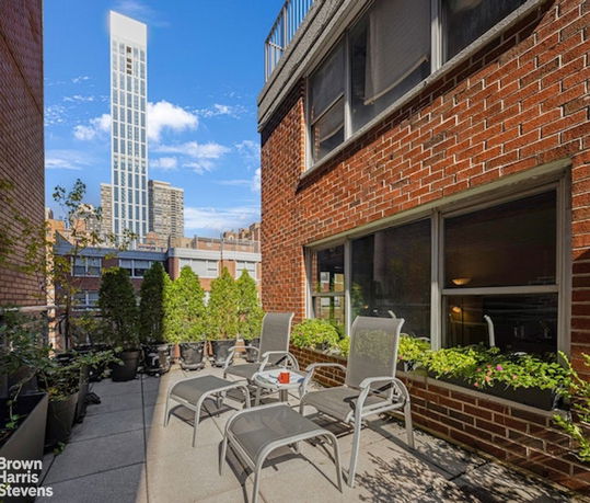 Rooftop area with lounge chairs and potted plants