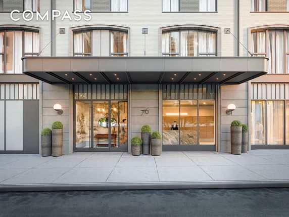 Front view of a multi-story building entrance with a modern canopy.