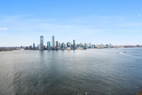 Panoramic view of a city skyline across the water.