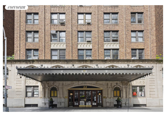 Front view of a multi-story brick building with decorative entrance canopy.