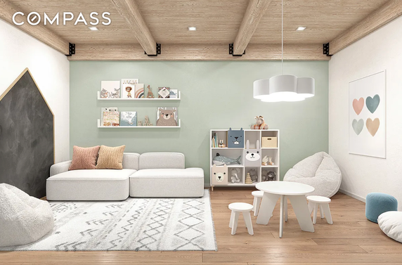 Indoor play area with cozy seating, shelves with toys, and a small table with stools.