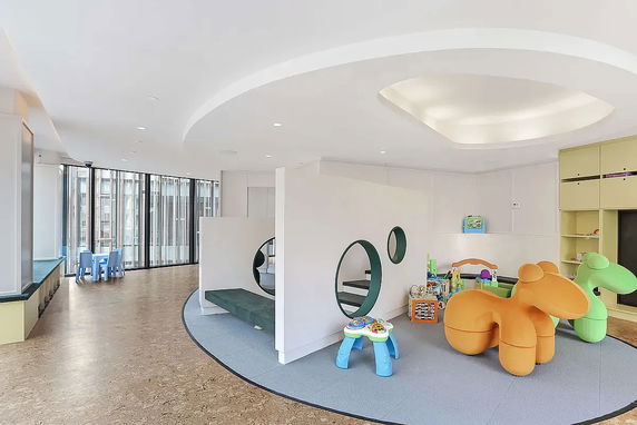 Indoor play area with colorful toys and seating.