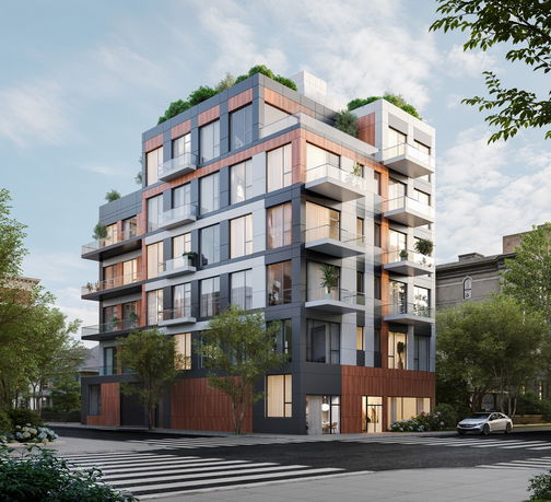 Front view of a modern multi-story apartment building with large windows and balconies.