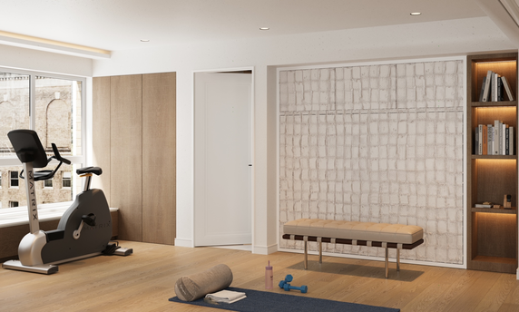 Indoor gym area with exercise bike, yoga mat, and weights.