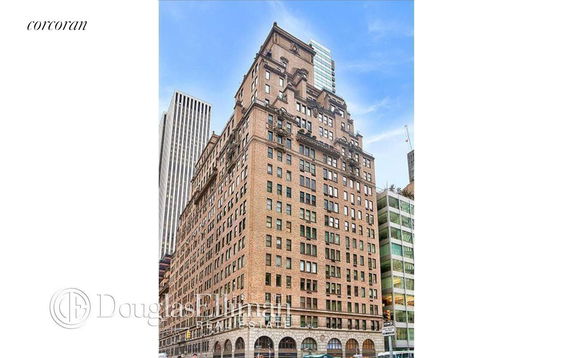 Front view of a multi-story brick building with ornate architectural details.