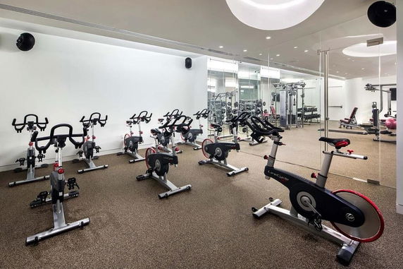 Indoor gym area with exercise bikes and fitness equipment.