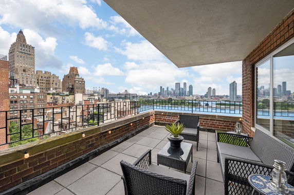 Panoramic view from a rooftop terrace with outdoor seating.