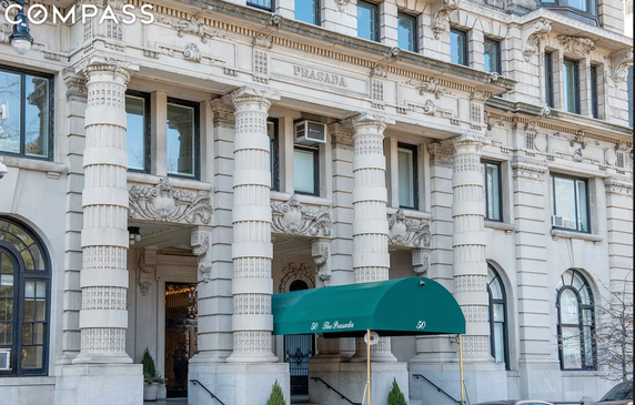 Front view of a grand building with decorative columns and ornate architectural details.