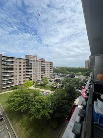 View of surrounding residential buildings from a balcony on a high-rise.