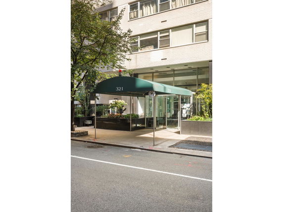 Front view of a multi-story building with a green canopy entrance.