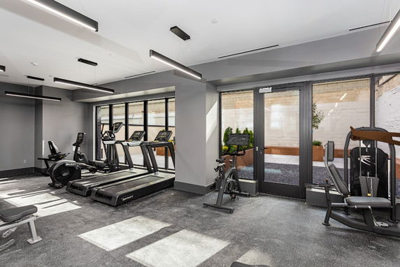 Indoor gym area with exercise equipment.