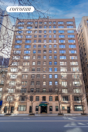 Front view of a multi-story brick building with numerous windows.