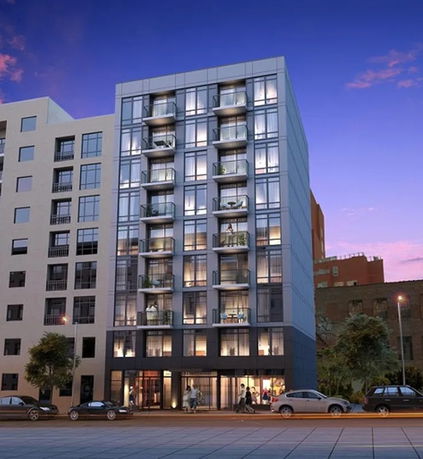 Front view of a modern multi-story apartment building with balconies.