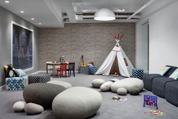 Indoor play area with a tent, seating, and toys