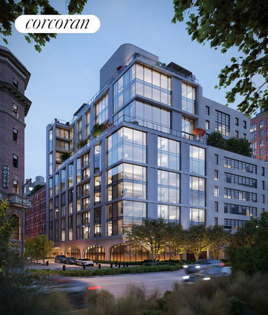 Modern multi-story building with large glass windows and balconies.