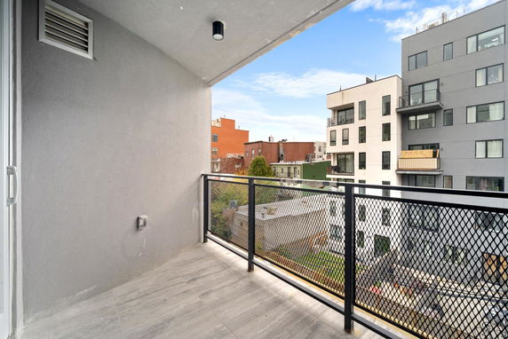 View from a balcony overlooking surrounding buildings.