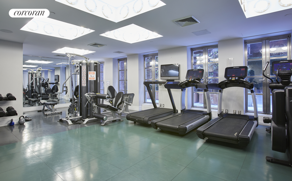 Interior of a gym with exercise equipment and treadmills.