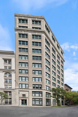 Front view of a multi-story building with large windows.