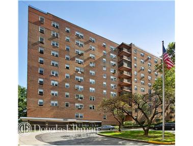 Front view of a multi-story brick apartment building.
