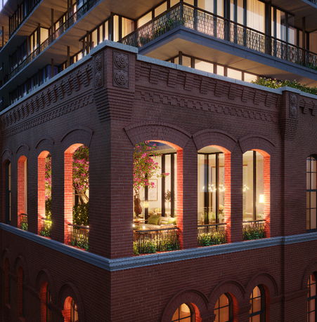 Front view of a multi-story building with brick facade and large windows.