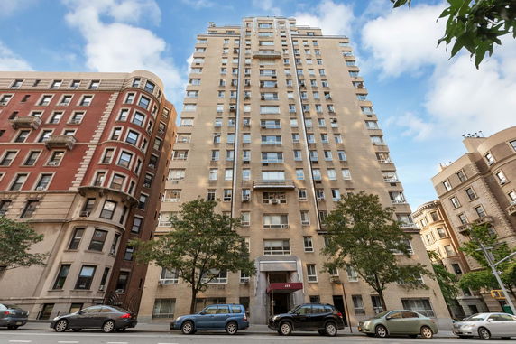 Front view of a tall residential building with multiple floors.