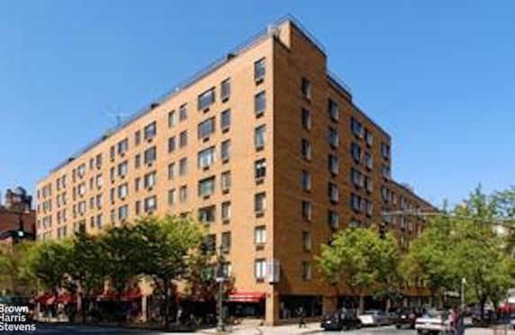 Front view of a multi-story brick apartment building.
