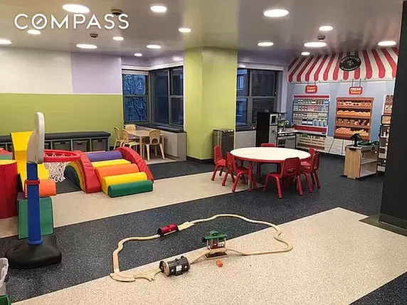 Indoor play area with colorful toys and children's furniture.