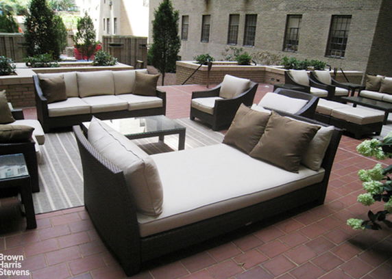 Outdoor patio area with cushioned seating and tables.