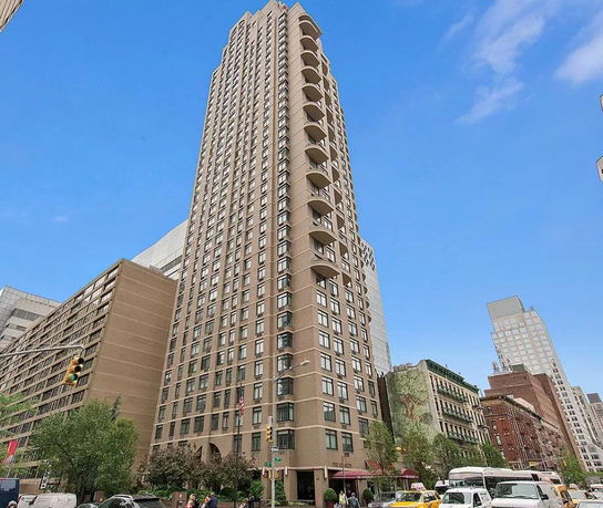 Front view of a tall multi-story building with balconies.