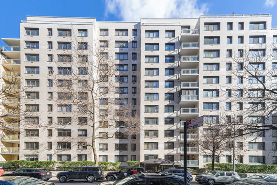 Front view of a multi-story apartment building with several balconies.