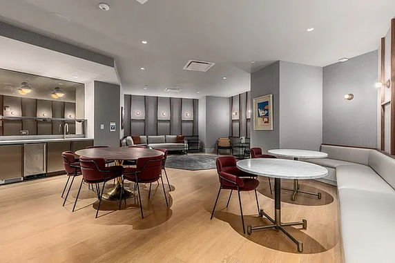 Recreational area with seating and a small kitchen area.