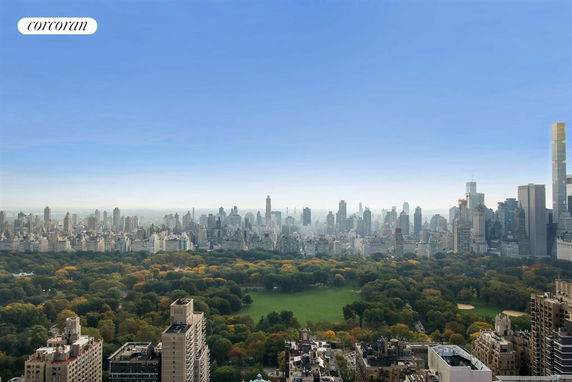 Panoramic view of a city skyline with a large park in the foreground.