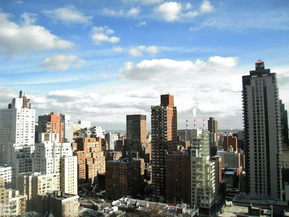 Panoramic view of a city skyline with multiple high-rise buildings.
