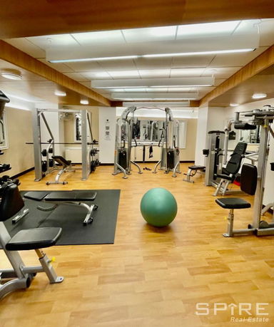 Indoor gym area with various exercise equipment.
