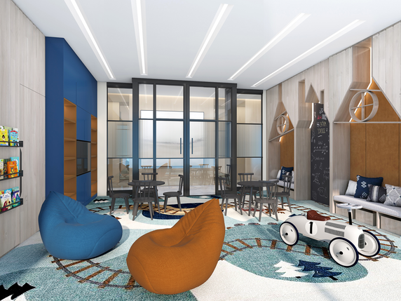 Interior view of a children's playroom with bean bags and a toy car.