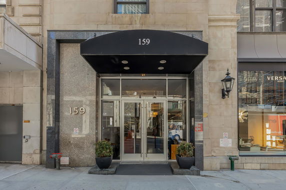Front view of a building with an entrance marked '159' and a black canopy.