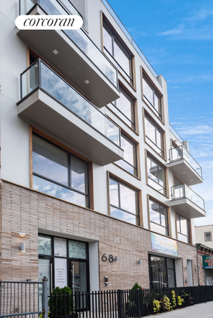 Front view of a modern multi-story building with balconies.