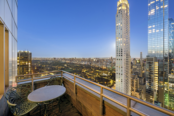 Balcony view overlooking a city skyline at dusk.