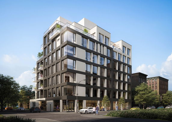 Front view of a multi-story modern building with large windows.