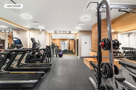Indoor gym area with fitness equipment like treadmills, weights, and benches.