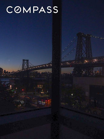 Panoramic view of a bridge and city skyline at dusk.