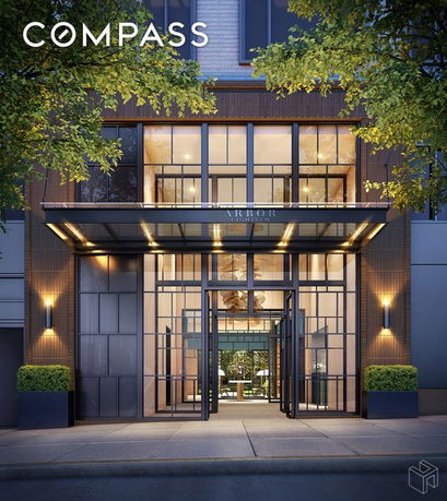 Front view of a modern building entrance with large glass windows.