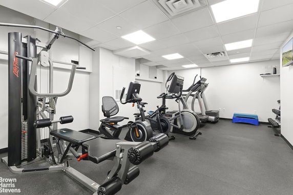 Indoor gym area equipped with exercise machines and equipment.