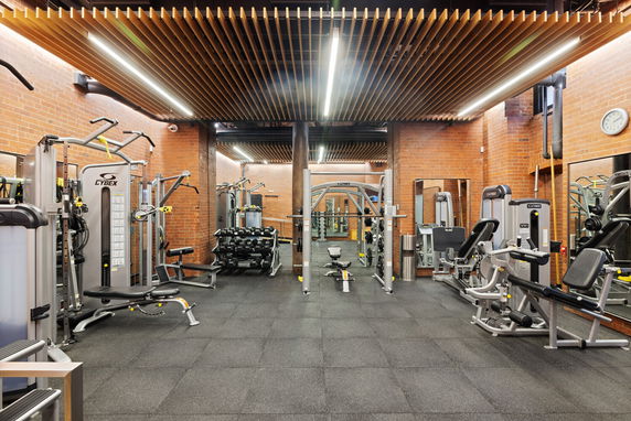 Interior view of a gym with exercise machines and equipment.