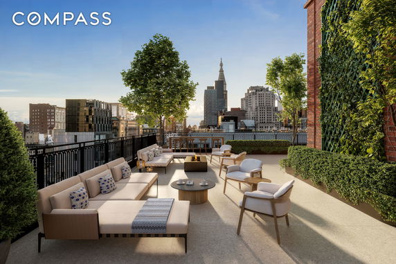 Rooftop terrace with seating and city skyline view.