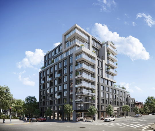Front view of modern multi-story buildings with glass balconies.